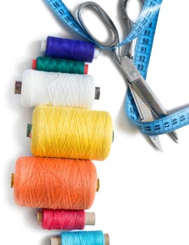 Colorful,Thread,Spools,,Scissors,And,Tape,Measure,On,White,Background